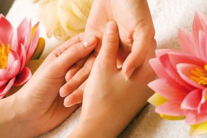 Hand massage being performed on client to relieve ailments