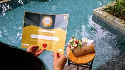 person holding gift voucher over pool